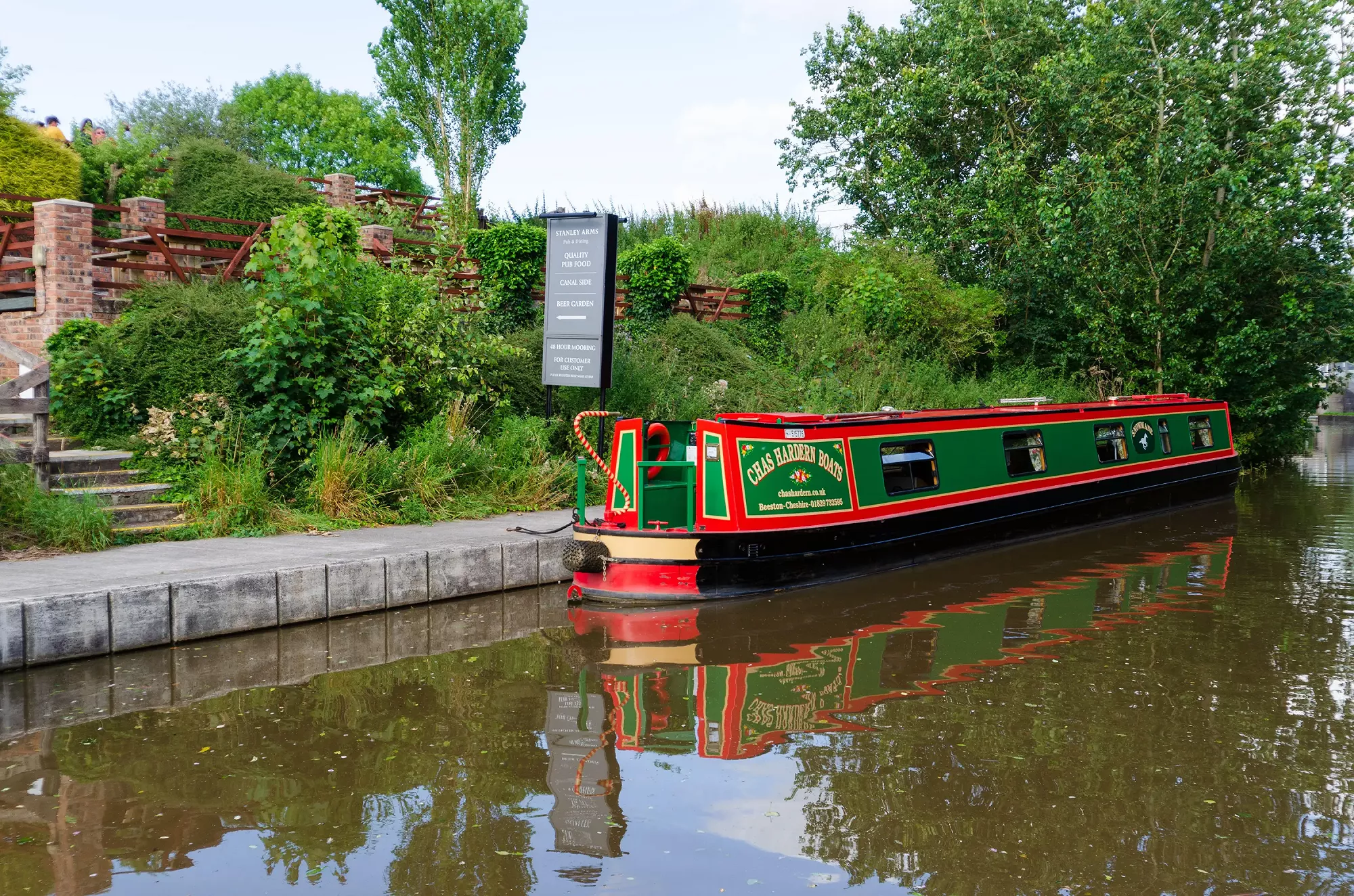 Holiday narrowboat strider moored at a canal-side pub.