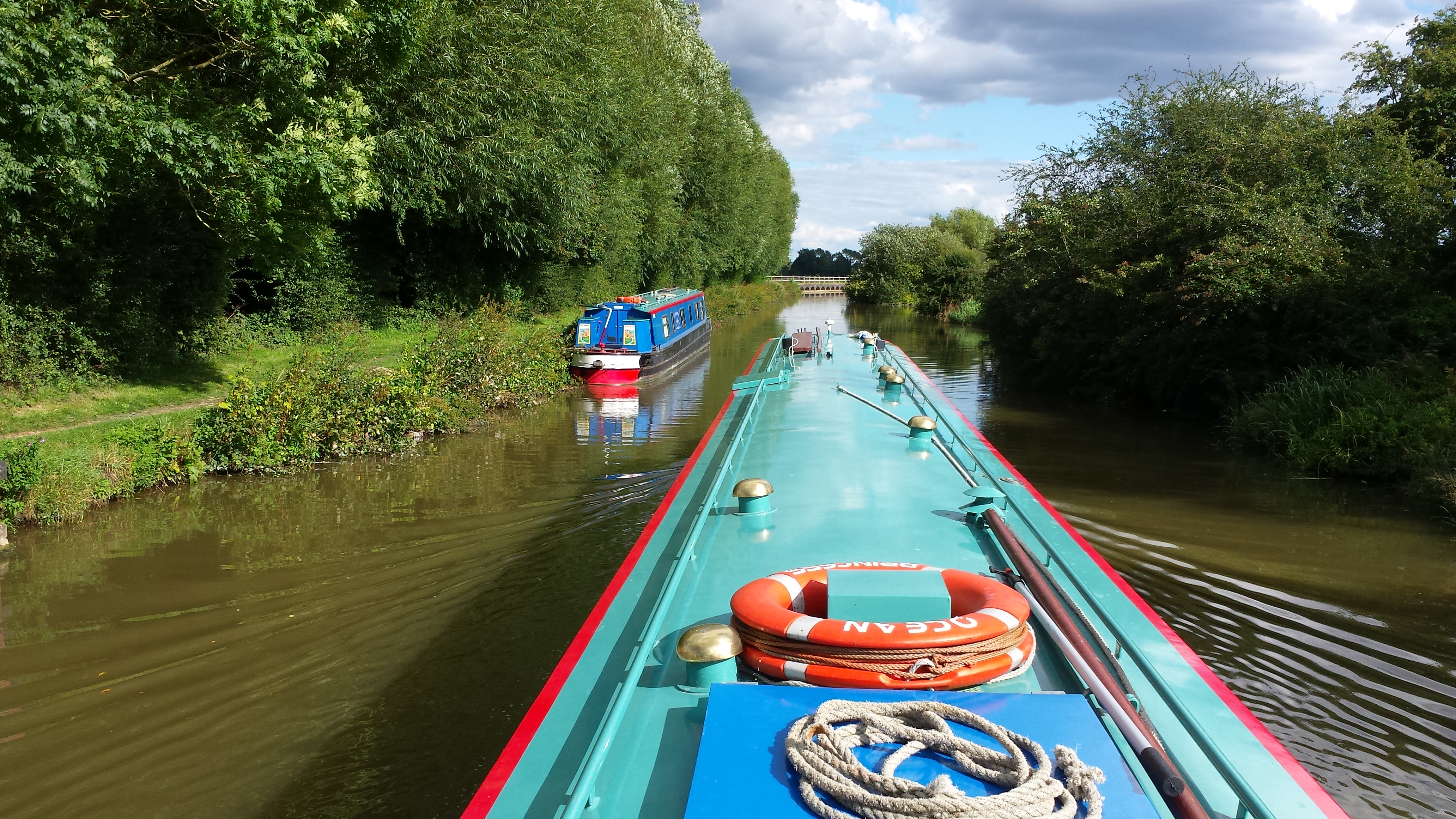 Holiday makers working their hire boat though a lock