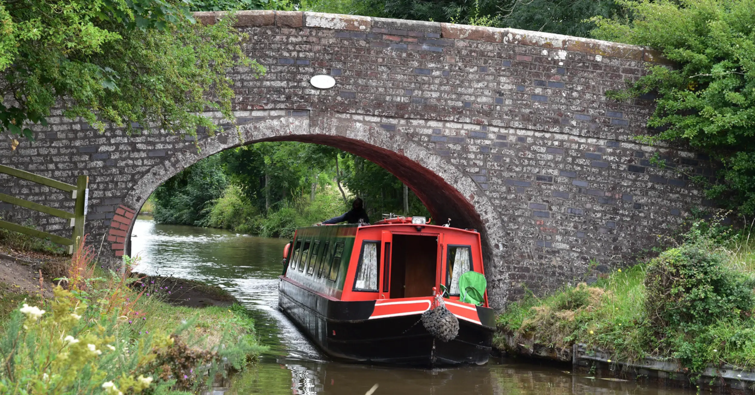 Holiday makers working their hire boat though a lock